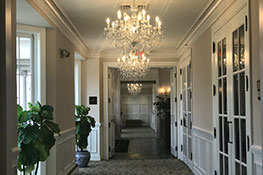 Hallway with chandeliers. Link to Life Stage Gift Planner Ages 60-70 Gifts.